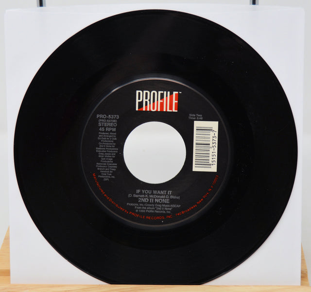 Black vinyl record with 'PROFILE' label on a white background