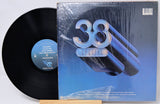 Vinyl record with a blue cover featuring the number '38' on a white background
