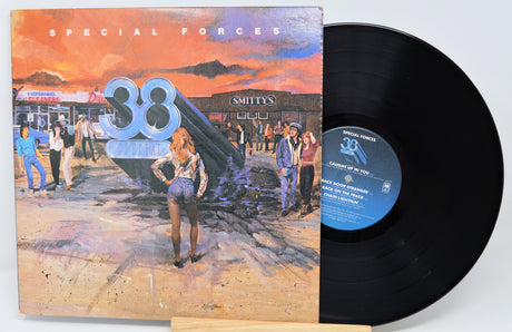 Vinyl record with cover featuring a stylized cityscape and person, labeled 'Special Forces'.
