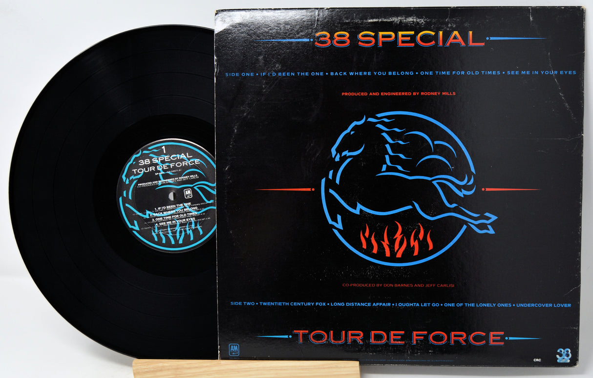 A vinyl record partially pulled from its black sleeve, showing the black disc and the cover art for 38 Special's 'Tour De Force'.