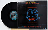 A vinyl record partially pulled from its black sleeve, showing the black disc and the cover art for 38 Special's 'Tour De Force'.