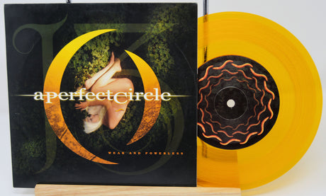 Vinyl record with a perfect circle cover and yellow disc