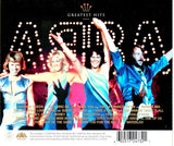 ABBA band members on stage with Greatest Hits tracklist on album back cover