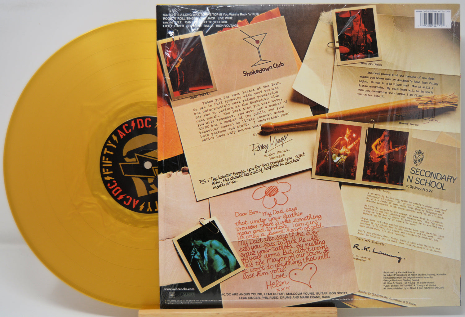 Gold vinyl record with a detailed back cover featuring text and images.