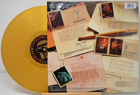 Gold vinyl record with a detailed back cover featuring text and images.