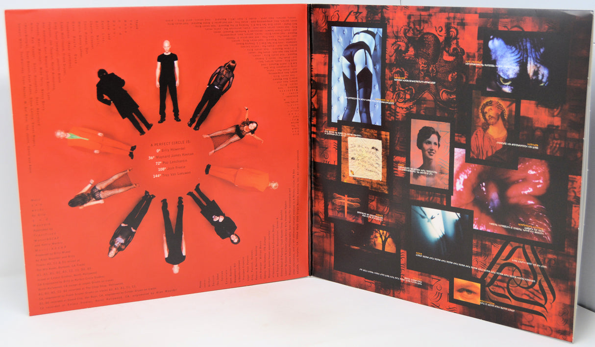 An open art book or magazine spread, showing a bright red left page with circular cutout figures and a dark collage-style right page filled with black, red, and blue imagery.