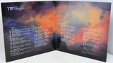 Shows a picture of a colorful cloudy sky and the song and credit listing for all 23 songs.