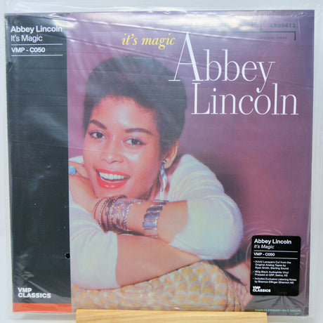 Abbey Lincoln's 'It's Magic' vinyl record LP on a wooden display stand, sealed in its original plastic shrink wrap. The cover art features a portrait of the artist against a purple background, with a black spine band on the left.