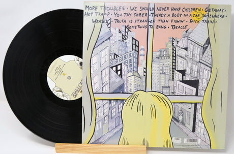 A used vinyl record of Absentee - Schmotime with the album cover in the background.