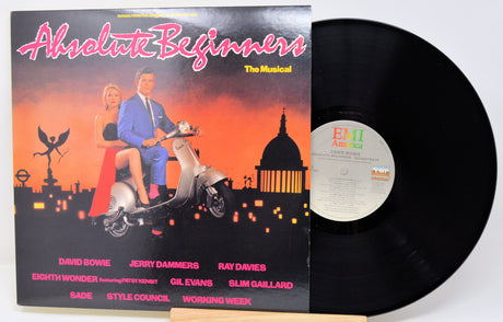 Vinyl record with cover featuring a couple on a scooter against an orange sky.