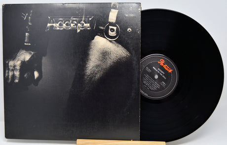 Accept's 'Blind Gaze' vinyl record LP with its black cover art sleeve and a black vinyl record partially pulled out, displayed on a small wooden stand against a light gray background.
