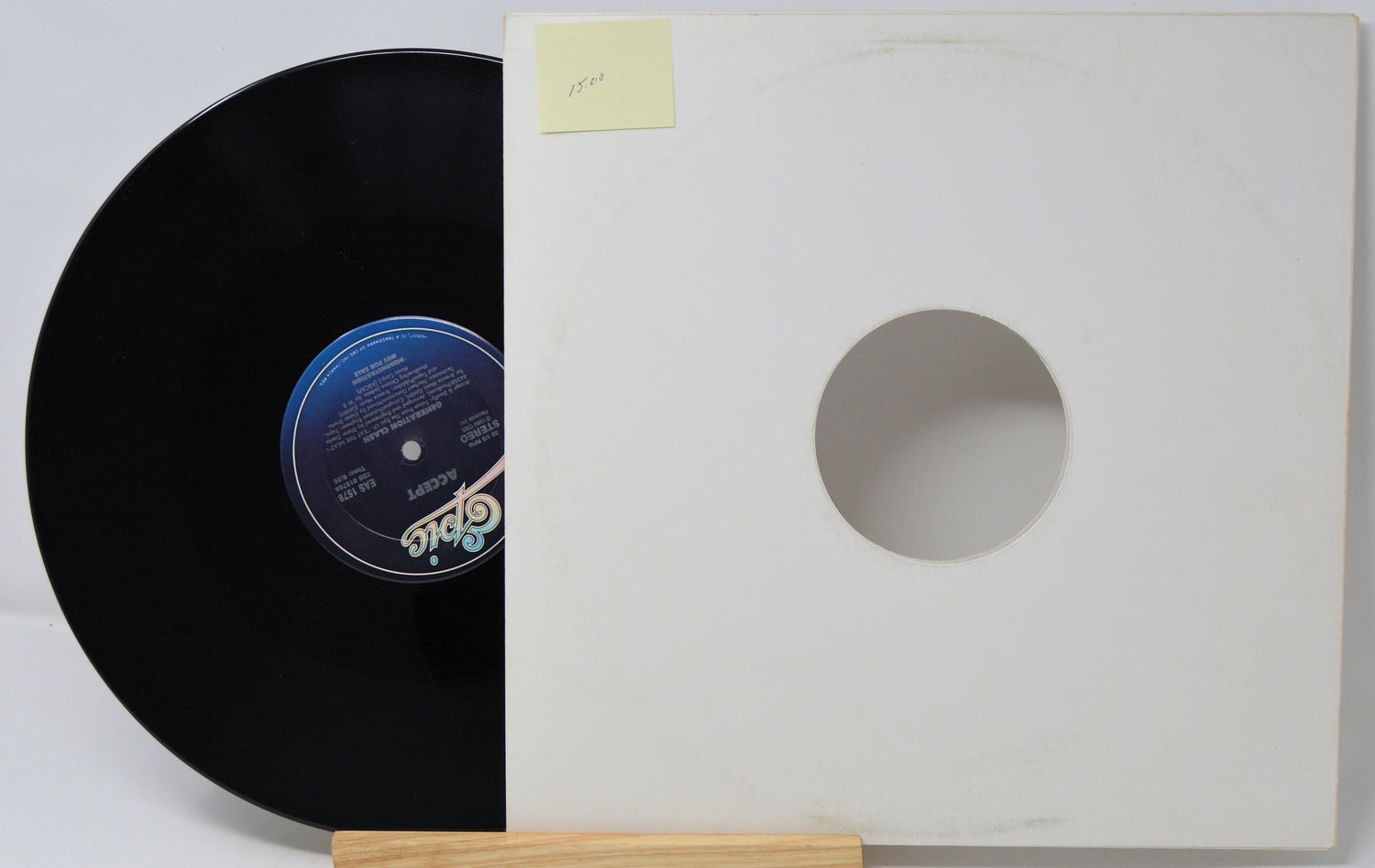 Vinyl record with a white sleeve on a light gray background