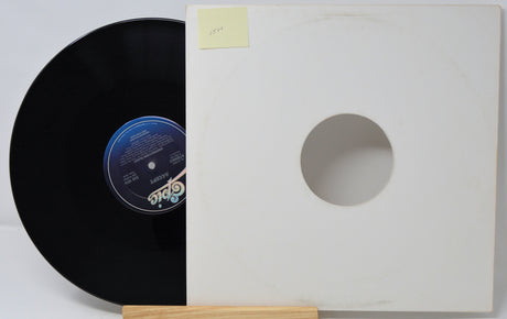Vinyl record with a white sleeve on a light gray background