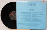 Vinyl record with blue cover featuring 'Accept' and text on a light gray background