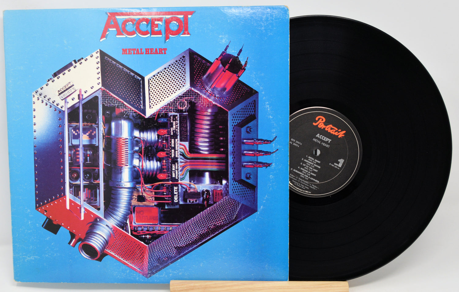 Vinyl record with a blue cover featuring intricate design and 'ACCEPT' branding.