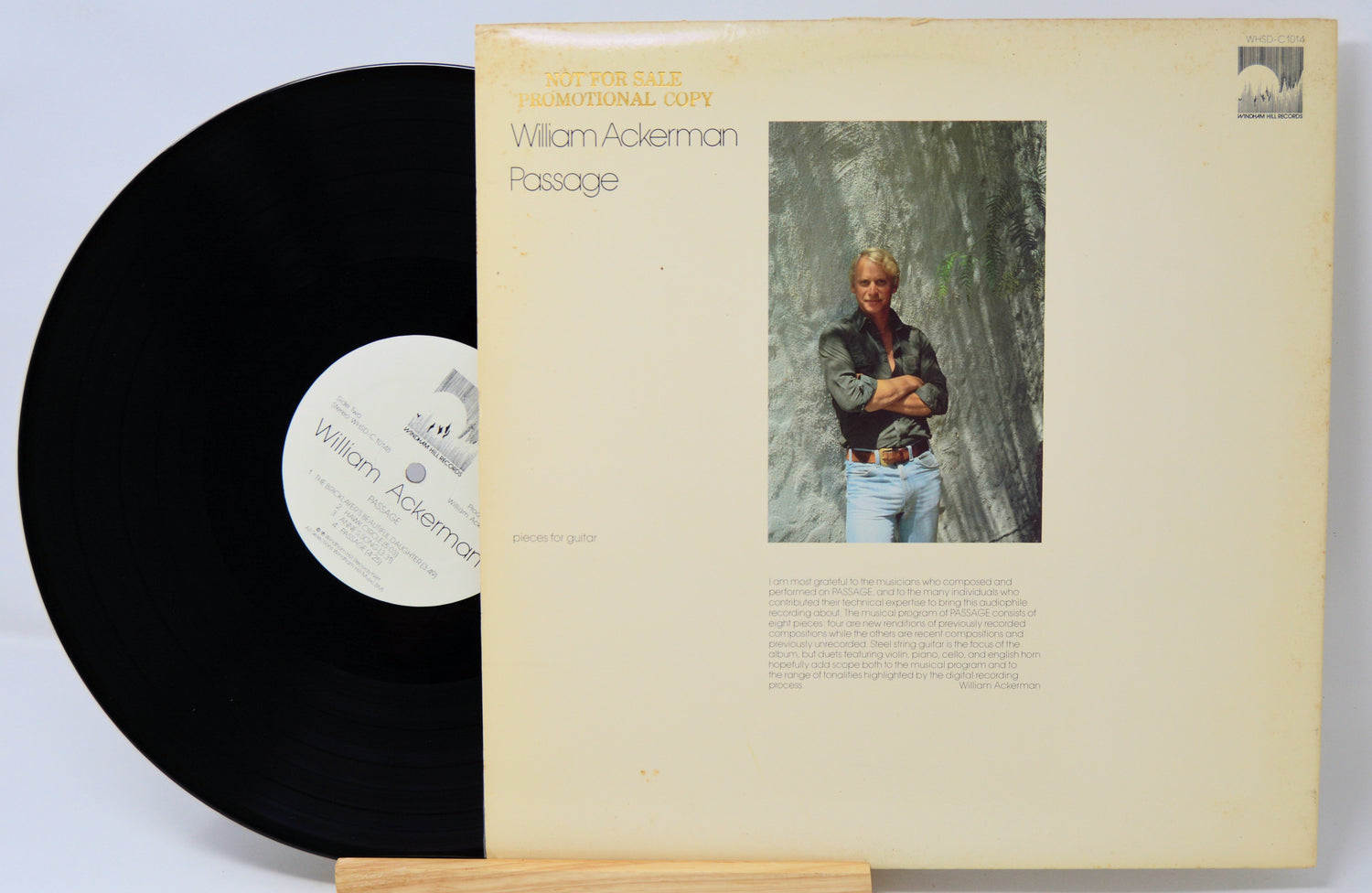Vinyl record with cover featuring a person against a tree, on a light gray background