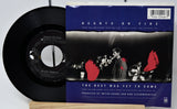 Vinyl record and its cover titled 'Hearts on Fire' by Bryan Adams on a white background.