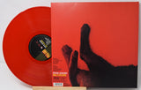 Red vinyl record with a black cat illustration on the cover