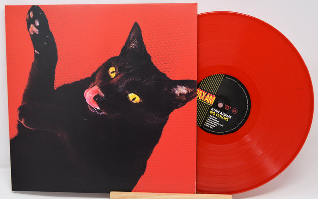 Red vinyl record with a black cat illustration on the cover