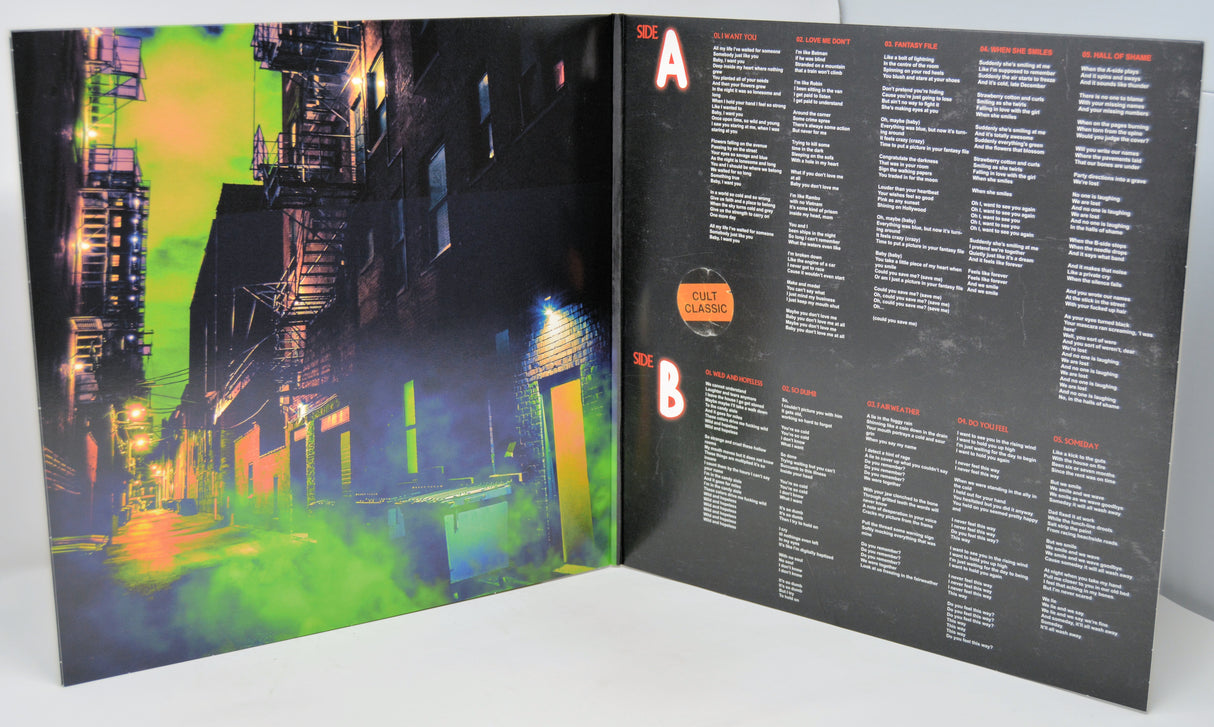 Vinyl record cover with colorful cityscape on one side and tracklist on the other, on a white background.