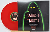 Red vinyl record with a black cover featuring a silhouette and text.