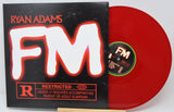 Red vinyl record with 'FM' and 'Ryan Adams' on a black cover