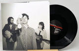 Vinyl record with a black and white photo cover featuring musicians.