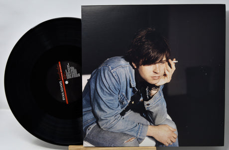 Vinyl record with a person on the cover against a dark background