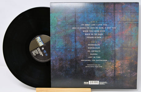Vinyl record with cover featuring a forest design and tracklist.