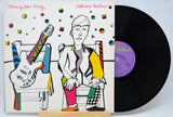 Vinyl record 'Adrian Belew Twang Bar King' with a colorful cover featuring a stylized illustration of a person and guitar, on a white background.