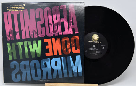 Vinyl record with colorful text on the cover and a white background