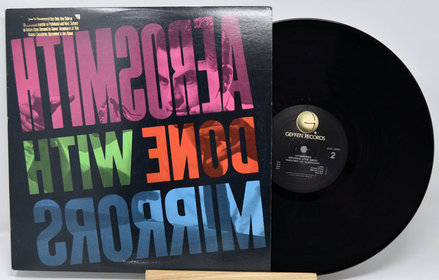 Vinyl record with colorful text on the cover and a white background