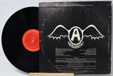 Vinyl record with Aerosmith album cover on a white background