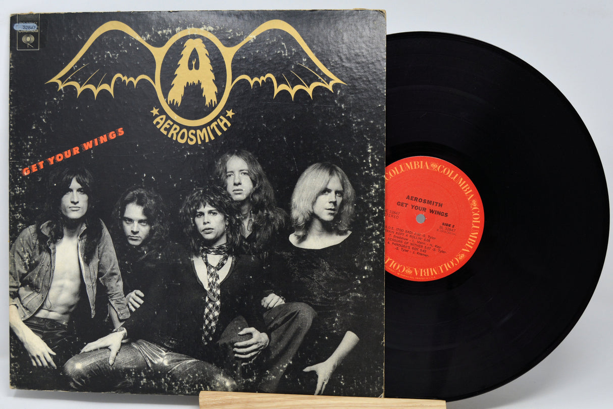 Vinyl record with Aerosmith album cover featuring band members and wings logo.