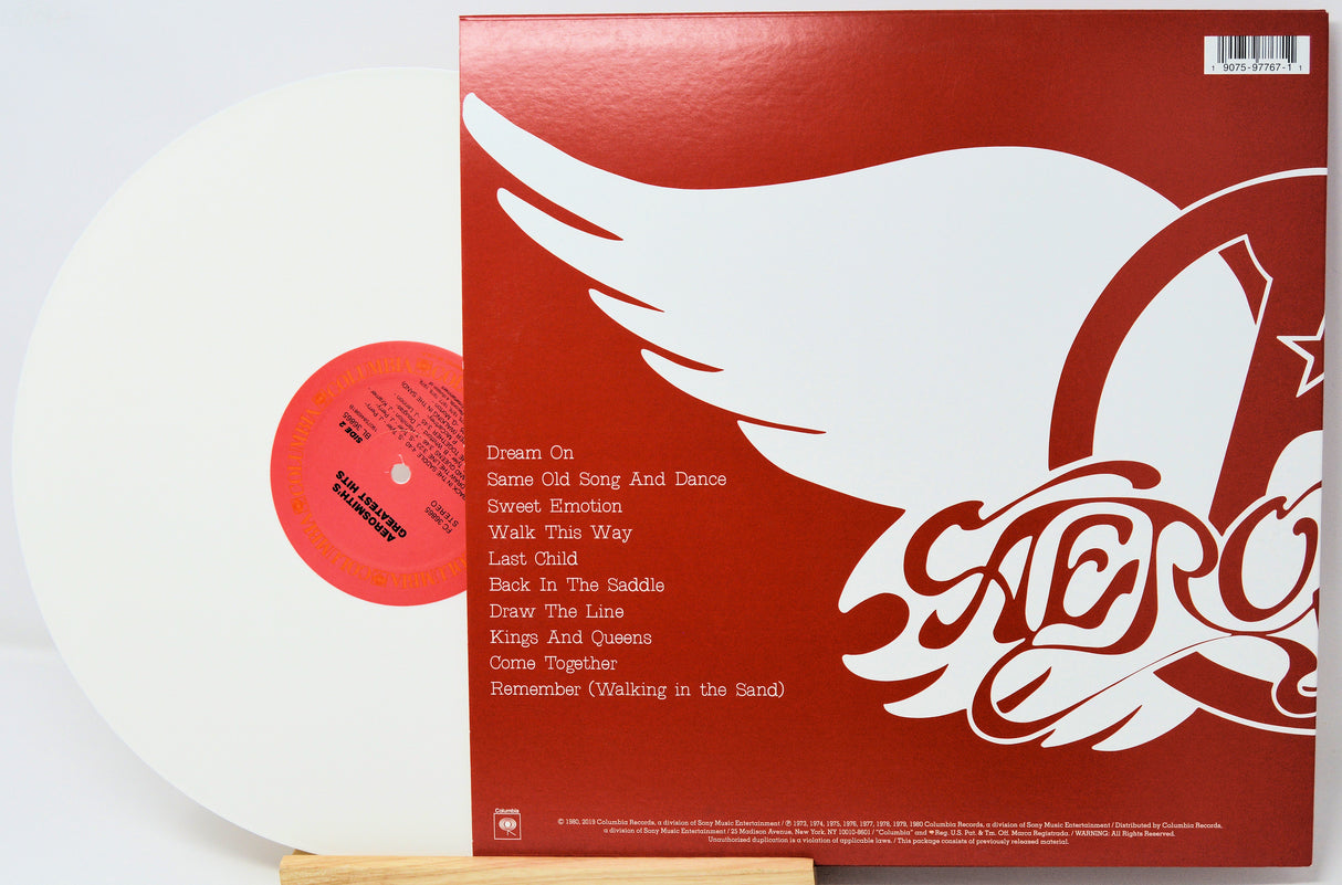 Vinyl record with red cover featuring a white dove and album title design.