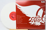Vinyl record with red cover featuring a white dove and album title design.
