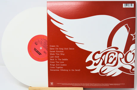 Vinyl record with red cover featuring a white dove and album title design.