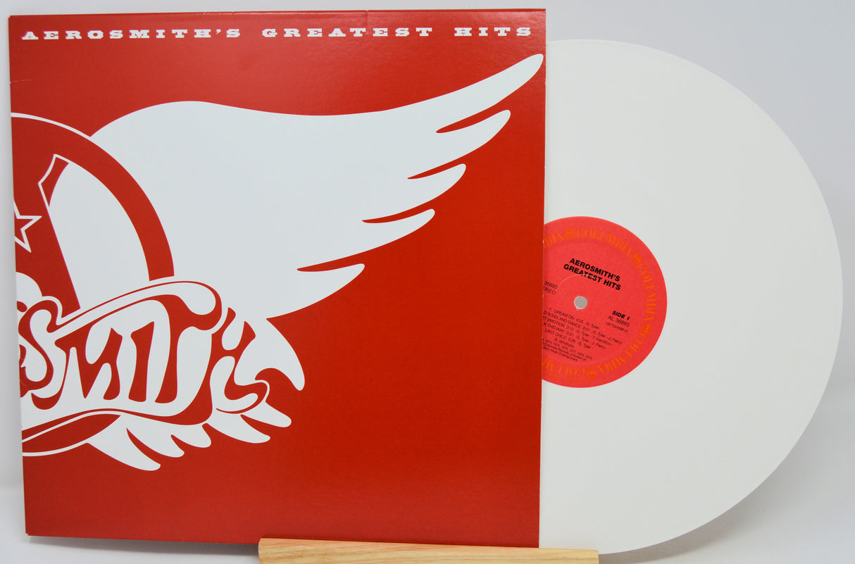 Vinyl record with red cover featuring Aerosmith logo and white wings on a white background
