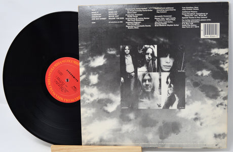 Vinyl record with a black cover featuring album artwork and text.