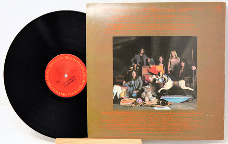 Vinyl record with cover featuring a group of people and animals on a white background