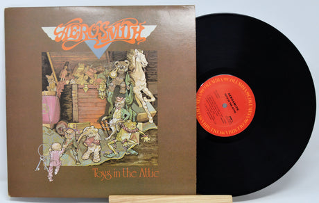 Vinyl record with cover titled 'Toys in the Attic' by Mercyful Fate on a white background.