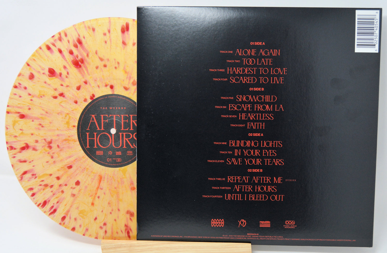 Yellow and red splatter After Hours vinyl LP partially covered by the album’s tracklist on black sleeve