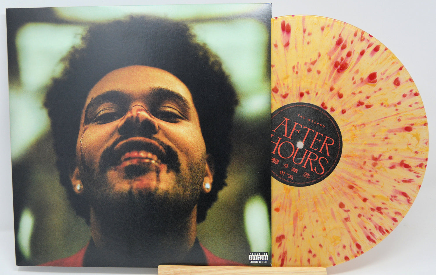 After Hours vinyl and cover featuring close-up of The Weeknd with nosebleed and smile