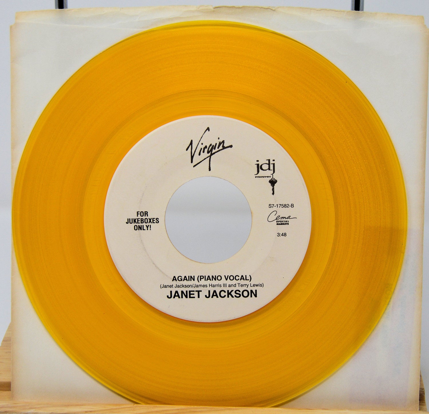 Janet Jackson Again yellow vinyl record jukebox single with piano vocal side displayed