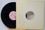 A vinyl record and its cover, with the record inside the cover showing the 'Aisha & Her Mama' tracklisting.