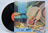 Vinyl record 'Al Di Meola Casino' with a colorful cover featuring a guitar and wicker chair.