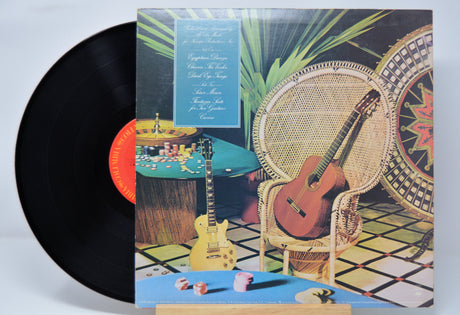 Vinyl record 'Al Di Meola Casino' with a colorful cover featuring a guitar and wicker chair.