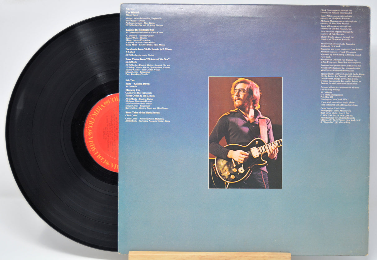 Vinyl record 'Al Di Meola Land Of Midnight Sun' with a cover featuring Al guitar on a blue background.