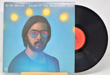 Vinyl record 'Al Di Meola Land Of Midnight Sun' with cover featuring Al wearing glasses against a blue background with lights.