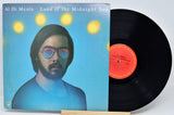 Vinyl record album 'Land of the Midnight Sun' by Al Di Meola, showing the blue illustrated cover with the record partially pulled out and revealing the black vinyl disc and orange center label.